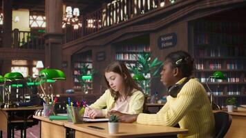 Teacher assisting scholars with class homework for mentoring session, providing academic instruction and support to help with the curriculum. Tutor lecturer gives private lessons. Camera A. video