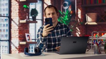 Happy employee at home office desk organizes calendar appointments, doing videocall with coworkers. Worker preparing for corporate event, doing remote videoconference meeting with colleagues, camera B video