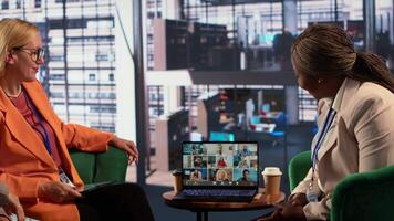 Diverse group of businesswomen participate in a remote conference call, showcasing leadership and cultural diversity in an inclusive workspace. Setting tasks in a briefing meeting. Camera A. video