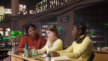 Female teacher engaging with schoolgirls during private lessons, provides mentoring session and guidance on specific curriculum subjects. Tutor helping classmates with grades. Camera A. video