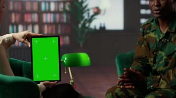 Black army soldier crying at therapy session next to chroma key screen, seeking professional support for PTSD and trauma recovery. Discussions for armed forces mental health care. Camera B. video