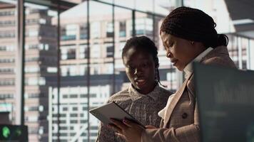 Business associates reviewing objectives data and performance metrics in a modern office, focusing on corporate strategy and decision making for sustainable enterprise development. Camera A. video