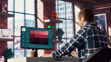 Man in apartment workspace using AI software turning text prompt into photos. Person in brick wall home uses text to image artificial intelligence generative models on computer, camera B video