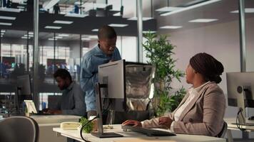Businesswoman engages with delivery employee highlighting food delivery services in a modern office. Black female manager serving her lunch and catching up on work tasks, efficiency. Camera B. video