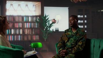 African american serviceman suffering from post traumatic stress disorder after army combat, therapy session with expert. Infantry trooper deals with shell shock, psychological care. Camera B. video