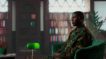 African american military trooper sharing flashbacks from the war during counseling session, tying to cure PTSD and shell shock. Army veteran deals with depression after traumatic scenes. Camera B. video