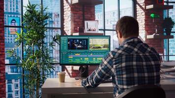 Remotely working videographer doing montage using specialized software applications. editor using editing tools on PC to cut movie project footage in home office, camera A video