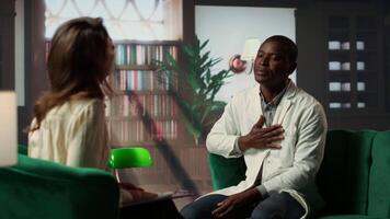 Psychiatrist in a serious conversation with a medic practitioner, listening to medical career difficulties and mental health struggles. Powerless doctor discussing about PTSD in therapy. Camera B. video
