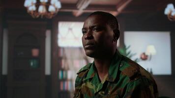 Armed forces trooper deals with depersonalization syndrome due to combat PTSD, feeling distressed and dissociative during therapy session. Black soldier with shell shock and trauma. Camera A. video