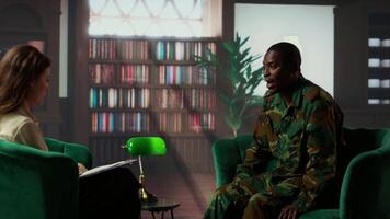 Military war veteran is in a vulnerable state opening up about combat horror scenes, crying and feeling frustrated after losing troopers. Serviceman discussing about traumatic experiences. Camera B. video