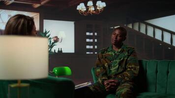 Military personnel sharing feelings about combat flashbacks during therapy, joining a rehabilitation program for armed forces troopers. Soldier opening up about PTSD and shell shock. Camera B. video