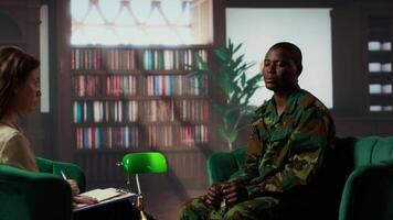 African american war veteran being dissociative and suffers from depersonalization, trying to cure shell shock after bloody combat scenes. Army soldiers experiences derealization condition. Camera B. video