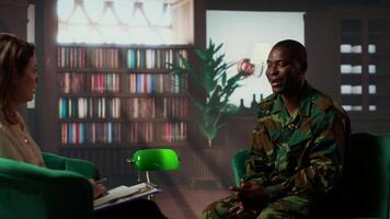 Counselor offering support to war veteran during therapy session, suffering from bipolar disorder and shell shock. Distraught serviceman dealing with war flashbacks, traumatic experiences. Camera b. video