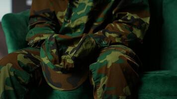 Armed forces trooper deals with depersonalization syndrome due to combat PTSD, feeling distressed and dissociative during therapy session. Black soldier with shell shock and trauma. Camera B. video