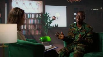 Counselor offering support to war veteran during therapy session, suffering from bipolar disorder and shell shock. Distraught serviceman dealing with war flashbacks, traumatic experiences. Camera A. video
