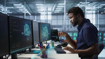 Engineer in data center implementing advanced AI driven predictive maintenance systems to proactively identify and resolve potential hardware failures before they impact operations, camera A video