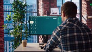 Man in home office using generative artificial intelligence website generating videos using diffusion models. Person wearing headphones using AI virtual assistant producing clips for him, camera A