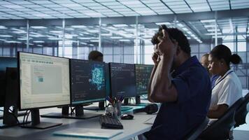 AI system administrator in server room listening music, developing disaster recovery plans ensuring minimal downtime. Neural networks specialist in data center monitoring performance, camera A video