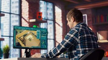 Man doing remote work on computer screen, moving assets in 3D modeling program. Teleworking interior designer using computer aided architectural design software on PC, camera B video