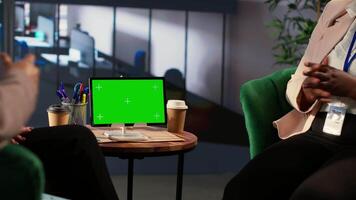 Diverse entrepreneurs look at isolated copy space display during meeting, planning fruitful collaboration between their companies. Group of businesswomen discuss about expansion ideas. Camera A. video