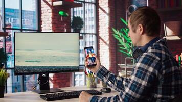Man in home office looking at social media feed with live broadcasts from online content creators. Employee at work using social network application with livestreams done by influencers, camera A video