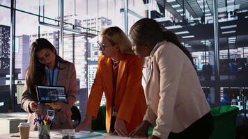 Multiethnic women executives uniting forces in a collaborative meeting, focused on data management and business development. Experts with leadership skills fighting for empowerment. Camera B. video