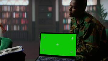 Military trooper studies Rorschach inkblot illustration next to green screen in therapy with psychologist, addressing PTSD and trauma recovery problems. Psychological support. Camera A. video