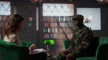 Anxious depressed private sharing his struggles with combat flashbacks, counseling session with psychiatrist for rehabilitation. Psychological support and reintegration for soldiers. Camera A. video