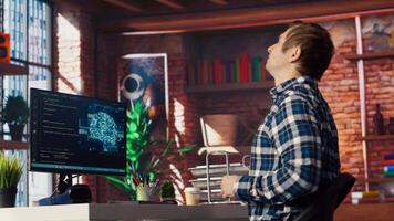 AI engineer in home office stretching back while looking at PC screen, feeling fatigued while executing code. Artificial intelligence developer feeling backpain, relieving pain, testing code, camera B video