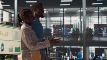 Forecast affiliates reviewing objectives data and performance metrics in a modern office, focusing on corporate strategy and decision making for sustainable enterprise development. Camera A. video