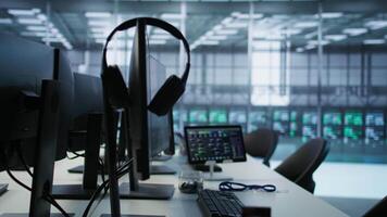 Close up of computer peripherals on server room desk used by employees working to ensure minimal downtime. Hard disk, keyboard and tablet in data center office used for monitoring performance video