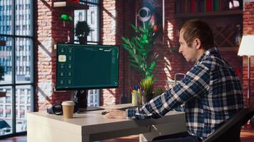 Man at home looking over documentation files to learn how to use text to generative models. Person in apartment reading technical specifications documents for AI program, camera A video
