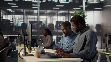 Black corporate team collaborate on global investment strategy, employing their extensive business expertise to work on data driven decisions. Solving administrative tasks for efficiency. Camera B. video