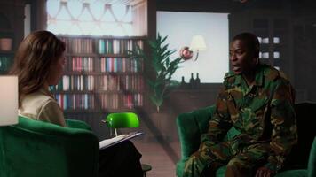 Military war veteran is in a vulnerable state opening up about combat horror scenes, crying and feeling frustrated after losing troopers. Serviceman discussing about traumatic experiences. Camera A. video