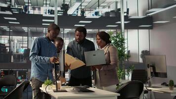 africano americano equipo colabora en un financiero planificación proyecto en un negocio espacio, enfatizando trabajo en equipo y datos análisis a hacer informado decisiones para futuro firma crecimiento. cámara b. video