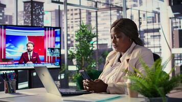 African american CEO texting messages about updates or business ideas with her team, shares project insight online on internet connection. Successful goal oriented director. Camera B. video