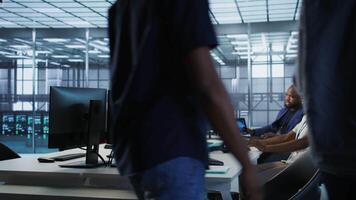 Technician entering data center, tuning music on and starting work on AI predictive maintenance systems. Server hub staff member using artificial intelligence to identify hardware failures, camera A video