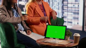 Diverse business experts working with mockup display on tablet, exchanging details in a briefing meeting. CEOs starting a collaboration with leadership skills, fighting for a success story. Camera A. video