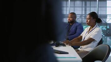 Technician entering data center, tuning music on and starting work on AI predictive maintenance systems. Server hub staff member using artificial intelligence to identify hardware failures, camera A video
