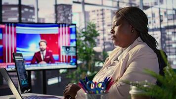 Determined black director driven by empowerment and ambition, achieving business targets and enhancing company performance in a dynamic office setting. Leadership success story. Camera B. video