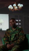 Vertical Portrait of army trooper meeting with a counselor to discuss about anxiety and distress due to PTSD and battle trauma, shell shock and mental disorder. Depressed trooper at counseling. Camera B. video