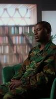 Vertical African american military trooper sharing flashbacks from the war during counseling session, tying to cure PTSD and shell shock. Army veteran deals with depression after traumatic scenes. Camera A. video