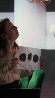 Vertical Counselor presents a Rorschach test to a medical assistant in uniform, looking for answers with psychoanalysis illustration. Nurse suffering from PTSD and trauma, interpretation therapy. Camera A. video