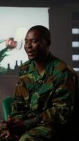 Vertical Counselor offering support to war veteran during therapy session, suffering from bipolar disorder and shell shock. Distraught serviceman dealing with war flashbacks, traumatic experiences. Camera b. video
