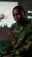 Vertical African american soldier in military uniform sits with an expert, viewing a Rorschach test illustration to share feelings and discuss trauma. PTSD and shell shock counseling session. Camera B. video