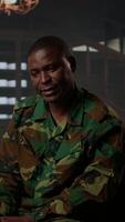 Vertical African american soldier in military uniform sits with an expert, viewing a Rorschach test illustration to share feelings and discuss trauma. PTSD and shell shock counseling session. Camera A. video