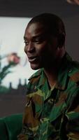 Vertical Black distraught war veteran crying due to shell shock and combat flashbacks, cure his anxiety after traumatic experiences. Army soldier dealing with a mental disorder during therapy. Camera B. video