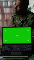 Vertical Military trooper studies Rorschach inkblot illustration next to green screen in therapy with psychologist, addressing PTSD and trauma recovery problems. Psychological support. Camera B. video