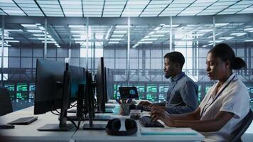 Admin arriving in server room, starting work on developing disaster recovery plans ensuring minimal downtime. Employee entering data center, beginning job shift, monitoring performance, camera A video