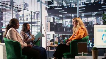 Female CEO and managers celebrating important corporate achievement, feeling pleased and happy with their business strategy. Businesswomen clapping hands in a men dominated environment. Camera B. video